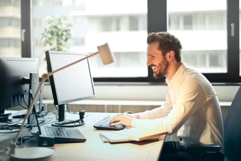 an excited man working on his computer